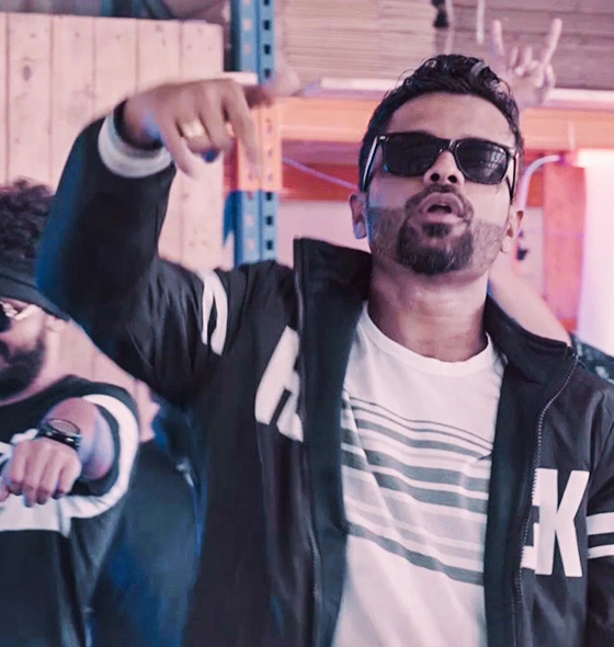 Snapshot from 'Asaneepe' music video. Rapper Samith Gomes performing in a dynamic scene.